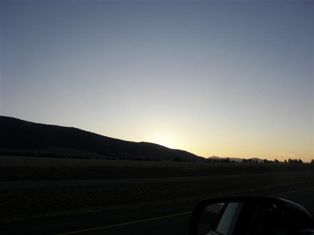 Sunrise behind a mountain on highway from Great Falls MT to Gates of the Mountains Rec Area #8 of 8 (#3029)